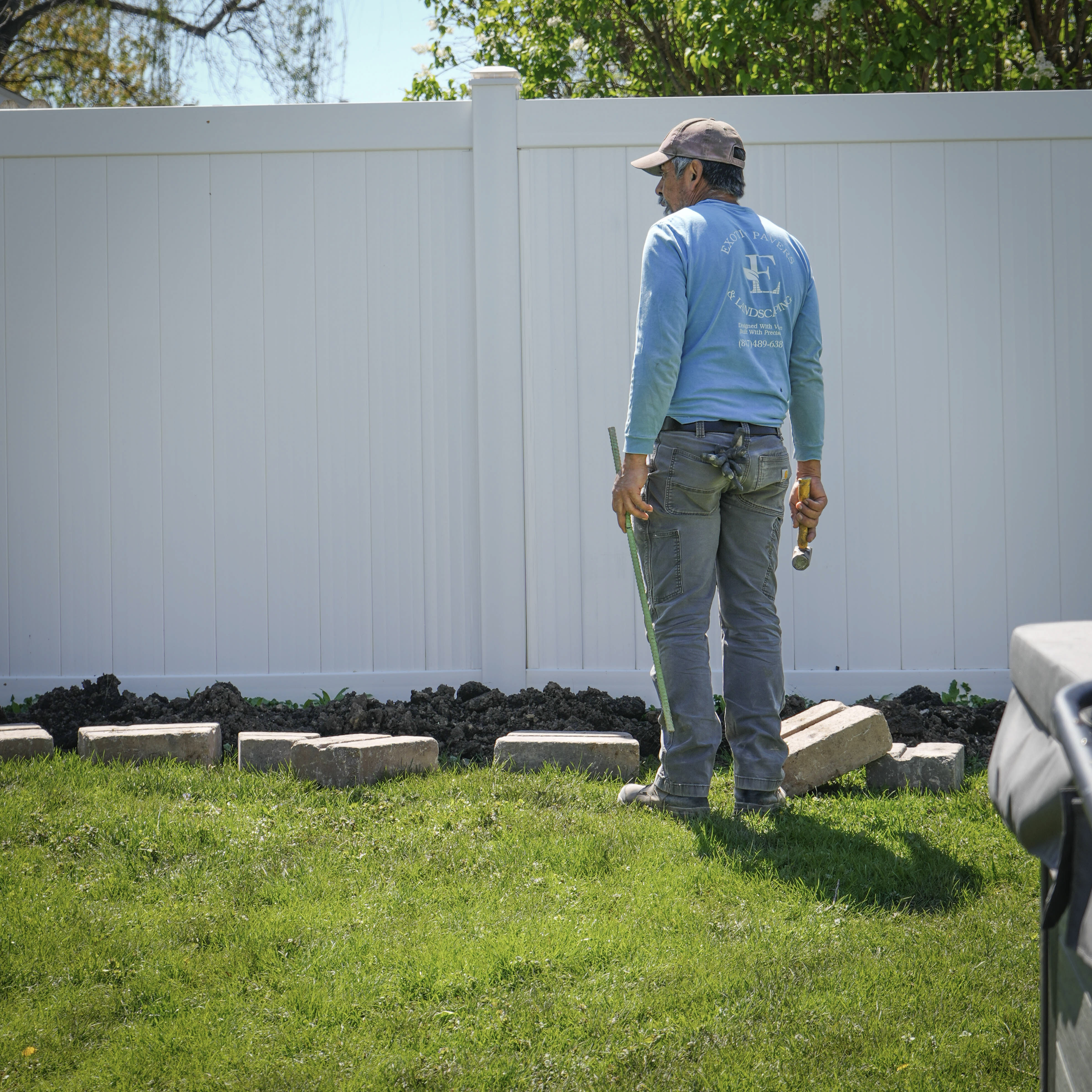 Crew measuring and marking the install line before excavation.