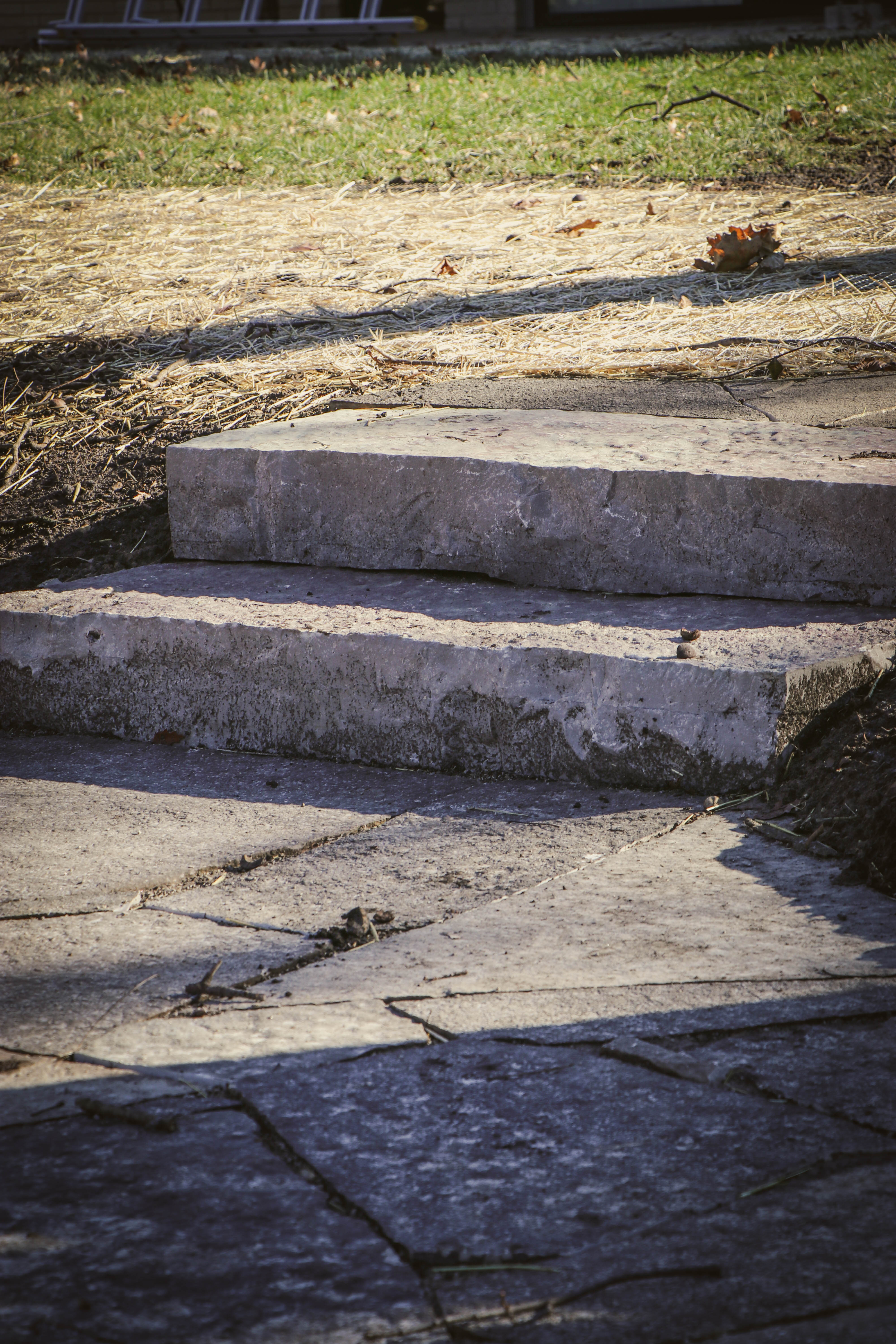 Close-up macro detail of stone steps transitioning to a flagstone walkway.
